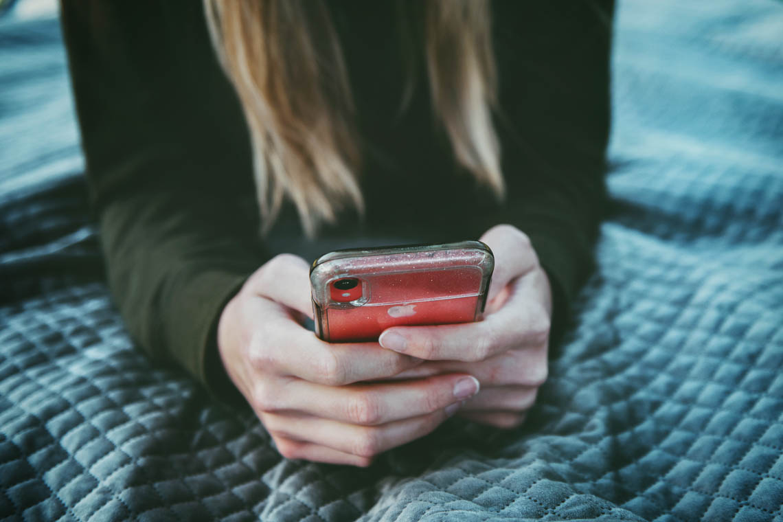 Close up of a person's hands holding an iPhone