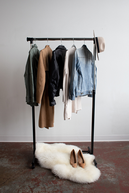 A rack full of women's clothes on a white background.