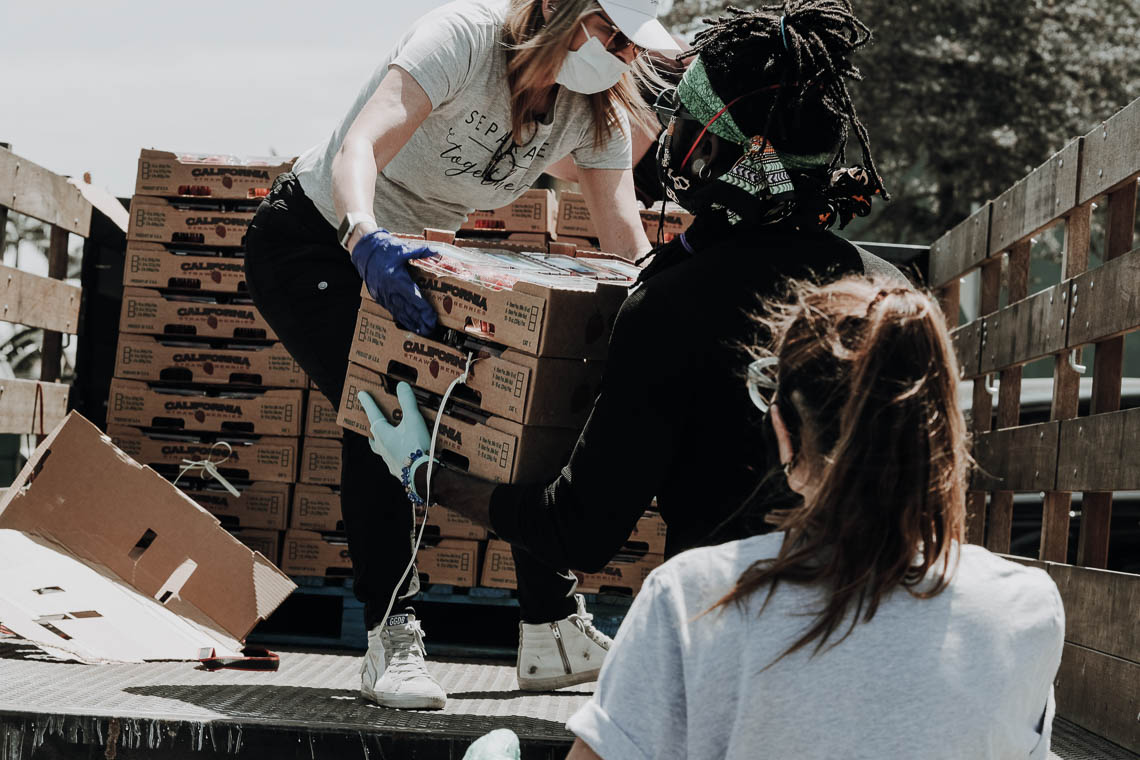 Three women working with a shipment of boxes