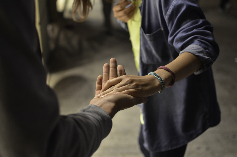 Close-up of two people holding hands