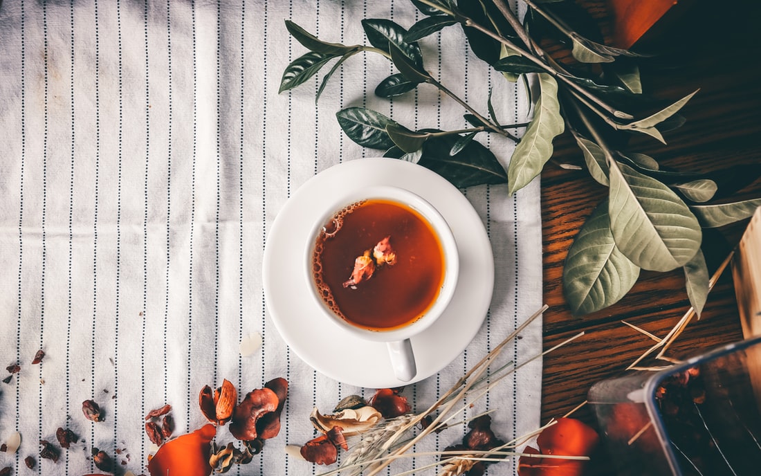 Overview image of mug of tea on a table with plants